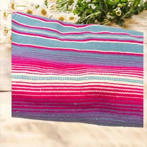 May include: A striped fabric with pink, blue, and white stripes. The fabric is woven with a variety of textures and colors.
