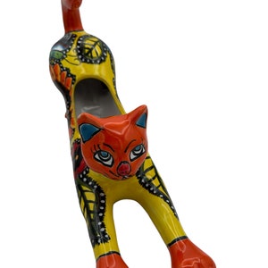 Talavera Cat stretching planter beautiful statue yellow body orange headwith flowers multicolored.