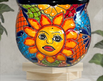 Talavera Sun face on plantet and on the back multicolored flowers.