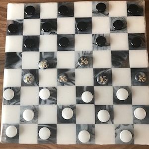 Checker board of fused glass and hand made fused glass checkers with chess pieces.