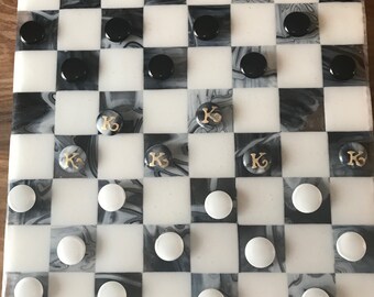 Checker board of fused glass and hand made fused glass checkers with chess pieces.