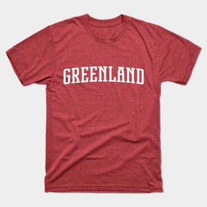 May include: A red t-shirt with the word "GREENLAND" printed in white on the front.