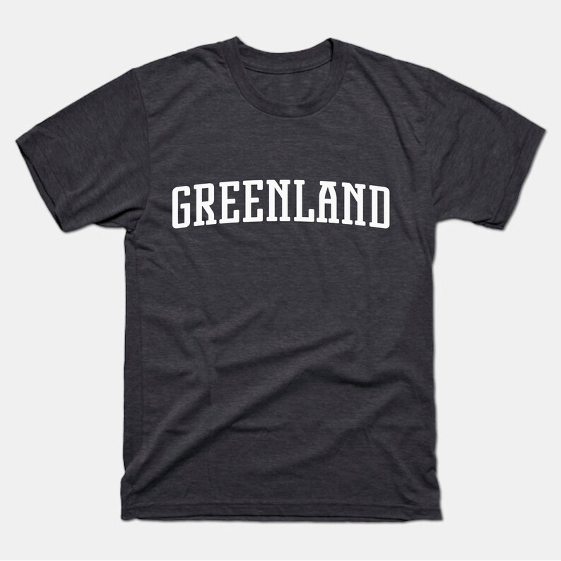 May include: A dark heather grey t-shirt with the word "GREENLAND" printed in white on the front.
