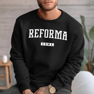 May include: Black sweatshirt with white text that reads "REFORMA CDMX".
