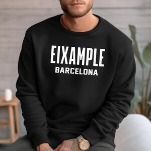 May include: Black sweatshirt with white text that reads "Eixample Barcelona".
