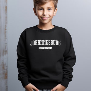 May include: Black sweatshirt with white text that reads "JOHANNESBURG" and "SOUTH AFRICA".