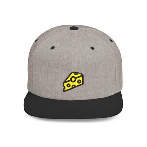 May include: A gray baseball cap with a black brim. The cap features a yellow cheese wedge graphic with black outlines. The cap has a flat brim and a structured crown, suitable for casual wear.