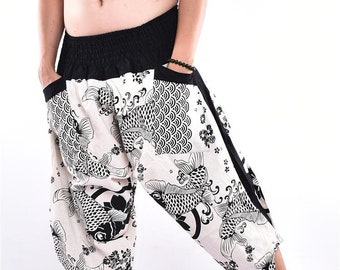 May include: White and black patterned cropped pants with a black waistband and pockets. The pattern features koi fish and floral designs. The pants are loose-fitting and casual.