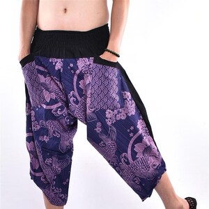 May include: Purple and blue patterned pants with a black waistband. The pants have a loose, flowing fit and feature a koi fish design.