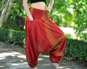May include: Red, orange, and green striped harem pants with a wide, gathered waistband. The pants are made of a soft, flowing fabric and have a loose, comfortable fit.