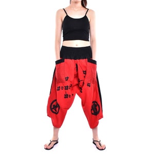 May include: Red and black patterned pants with a wide leg and a loose fit. The pants have a black waistband and black trim on the sides.