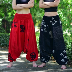 Puede incluir: Dos mujeres con pantalones holgados y estampados. Un par es rojo con dise&ntilde;os negros, el otro es negro con dise&ntilde;os blancos y grises.