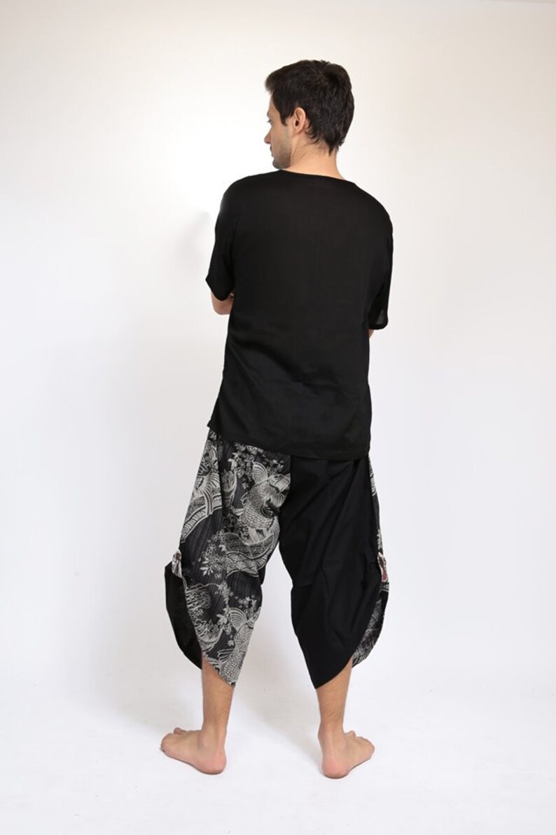 May include: A black short-sleeved shirt with a black and white patterned pair of pants. The pants have a loose fit and a wide leg.