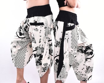 May include: A pair of white and black patterned pants with a black elastic waistband. The pants have a wide leg and a loose fit. The pattern features fish and floral designs.