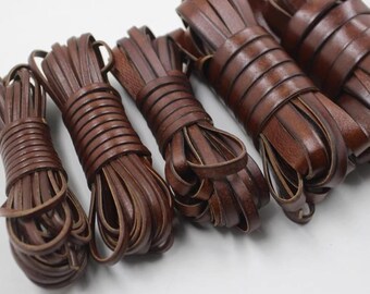 May include: Several bundles of brown leather strips are tightly coiled. The leather appears to be flat and of a medium brown color. The bundles are arranged in a row, with varying sizes, suggesting they are ready for use in crafting or repair.