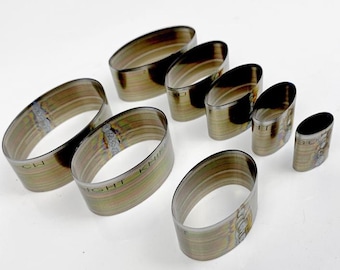 May include: A collection of oval-shaped metal leathercraft tools, varying in size, arranged on a white surface. The tools have a metallic finish with visible weld marks and the text "LIGHT KNIFE" is visible on some of the tools.