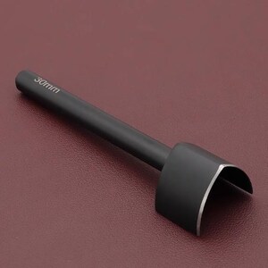 May include: A black leathercraft tool with a rounded, curved cutting edge. The tool has a long, cylindrical handle and the text "30mm" is printed on the handle. The tool is designed for cutting leather and other materials.