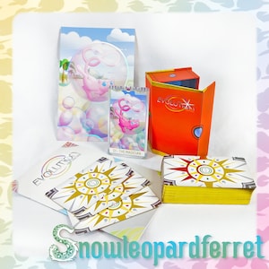 May include: A set of Evolution Tarot cards featuring a pink and white illustration of a Pokemon character on the card. The cards are in a yellow box with a red and gold design. The box is open and the cards are visible. The cards are on a white surface with a pink and white background.