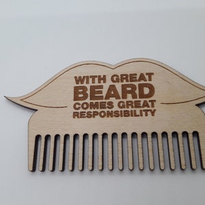 Op de afbeelding: Houten baardkam in de vorm van een snor met de tekst "With great beard comes great responsibility".