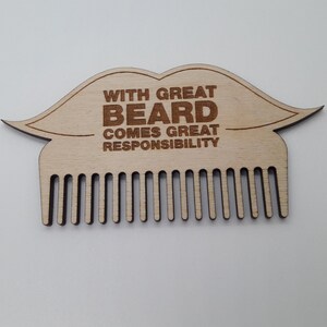 Op de afbeelding: Houten baardkam in de vorm van een snor met de tekst "With great beard comes great responsibility".