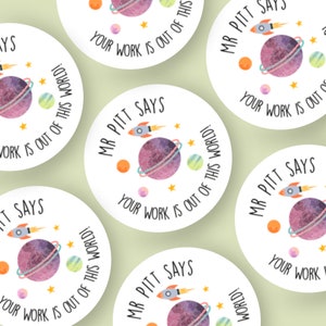 May include: Set of five round stickers with a space theme. Each sticker features a watercolour-style planet with rings, a rocket ship, and stars. The text "Mr. Pitt Says Your Work Is Out Of This World!" is printed on each sticker.