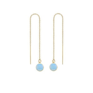 May include: A pair of gold chain earrings with light blue round stones hanging from the ends.