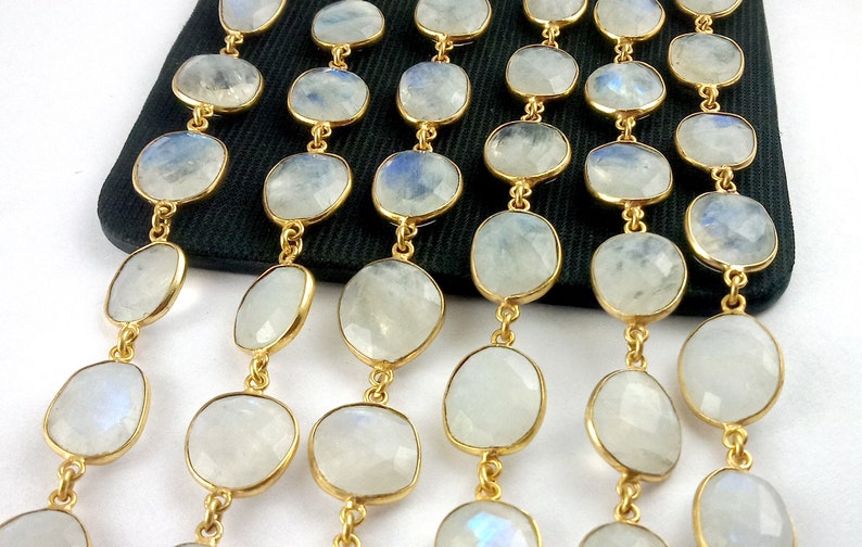 Peut inclure: Un brin de perles de pierre de lune blanche avec des accents dor&eacute;s. Les perles sont de forme ovale et ont une finition lisse et polie. Les accents dor&eacute;s sont petits et d&eacute;licats.