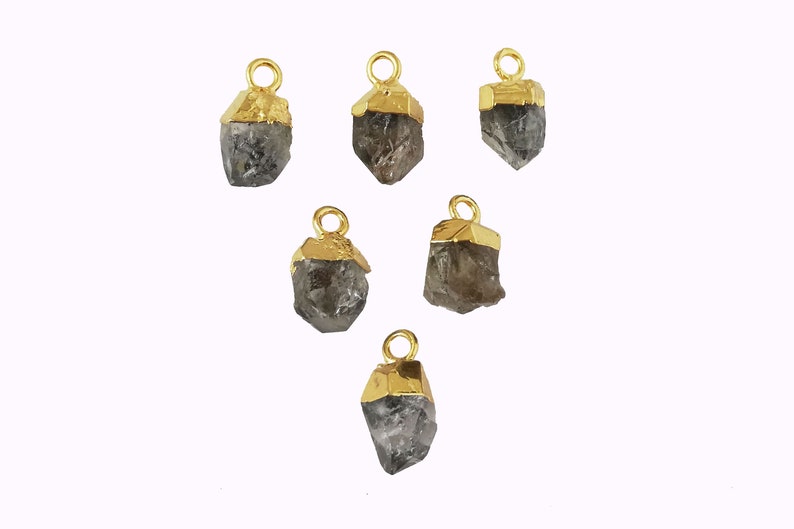 May include: Six gold-capped, grey crystal pendants. Each pendant has a loop at the top for attaching to jewellery.