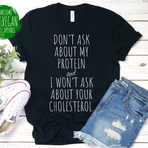 Vegan Saying Shirt, Don't Ask About My Protein And I Won't Ask About Your Cholesterol, Funny Veganism Awareness Gift, Premium Vegan T-Shirt