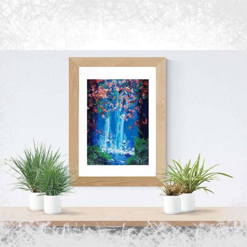 May include: A framed painting of a waterfall in a forest. The waterfall is blue and white, and the forest is green and brown. There are pink flowers in the trees. The painting is in a wooden frame.