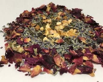 May include: A blend of dried tea leaves, lavender buds, rose petals, and dried apple pieces. The tea blend is a mix of green, purple, and orange colors.