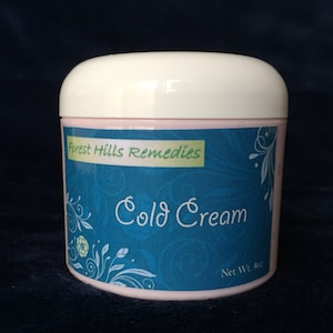 May include: A white jar with a blue and green label that says "Forest Hills Remedies Cold Cream" and "Net Wt. 4oz".
