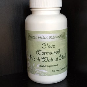 May include: White plastic bottle with a green label that reads "Forest Hills Remedies Clove Wormwood Black Walnut Hulls Herbal Supplement 200 Veg Capsules"