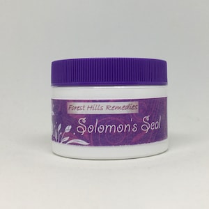 May include: A white jar with a purple lid and a label that says "Forest Hills Remedies Solomon's Seal". The label has a floral design in shades of purple and white.