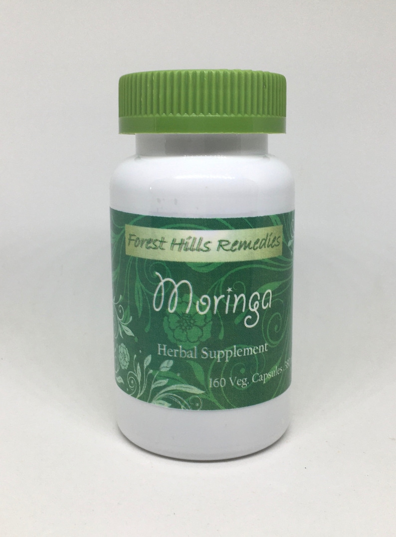 May include: A white bottle with a green lid and a green label that says "Forest Hills Remedies Moringa Herbal Supplement 160 Veg. Capsules"