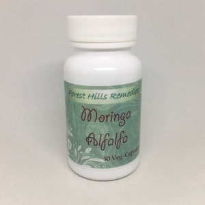 May include: White bottle with a green label that says "Forest Hills Remedies Moringa Alfalfa 30 Veg. Capsules".