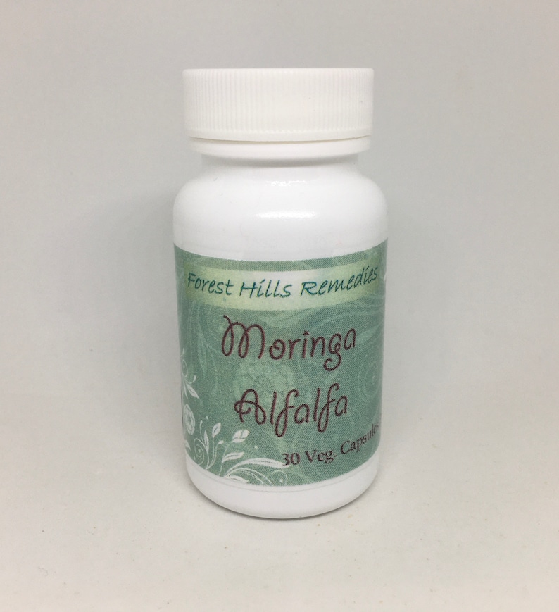 May include: White bottle with a green label that says "Forest Hills Remedies Moringa Alfalfa 30 Veg. Capsules".