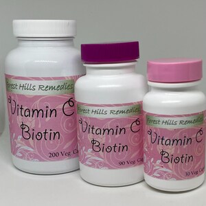May include: Three white supplement bottles with pink labels and lids. The labels read "Vitamin C Biotin" and "Forest Hills Remedies". The largest bottle has 200 capsules, the middle has 90, and the smallest has 30.