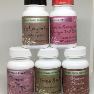 May include: Six white bottles with black lids and labels. The labels are pink and green with floral designs. The bottles contain herbal supplements. The labels read: Ashwagandha, Damiana, Sarsaparilla, Hydrangea, Irish Moss, Turmeric & Black Pepper, Fennel Seed, Gigartina Chlorella Spirulina.