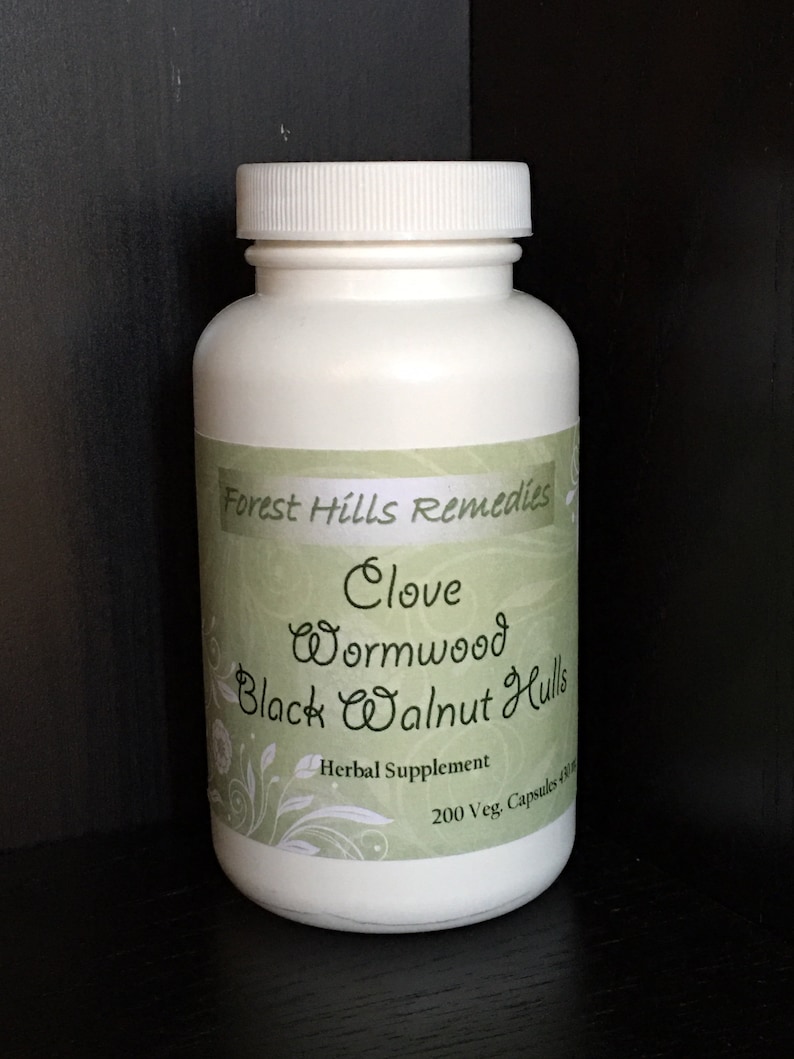 May include: White plastic bottle with a green label that reads "Forest Hills Remedies Clove Wormwood Black Walnut Hulls Herbal Supplement 200 Veg. Capsules 500 mg"