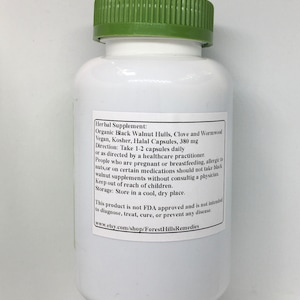 May include: White bottle with a green lid labeled "Herbal Supplement: Organic Black Walnut Hulls, Clove and Wormwood Vegan, Kosher, Halal Capsules, 380 mg Direction: Take 1-2 capsules daily or as directed by a healthcare practitioner. People who are pregnant or breastfeeding, allergic to nuts, or on certain medications should not take black walnut supplements without consulting a physician. Keep out of reach of children. Storage: Store in a cool, dry place. This product is not FDA approved and is not intended to diagnose, treat, cure, or prevent any disease. www.etsy.com/shop/ForestHillsRemedies"
