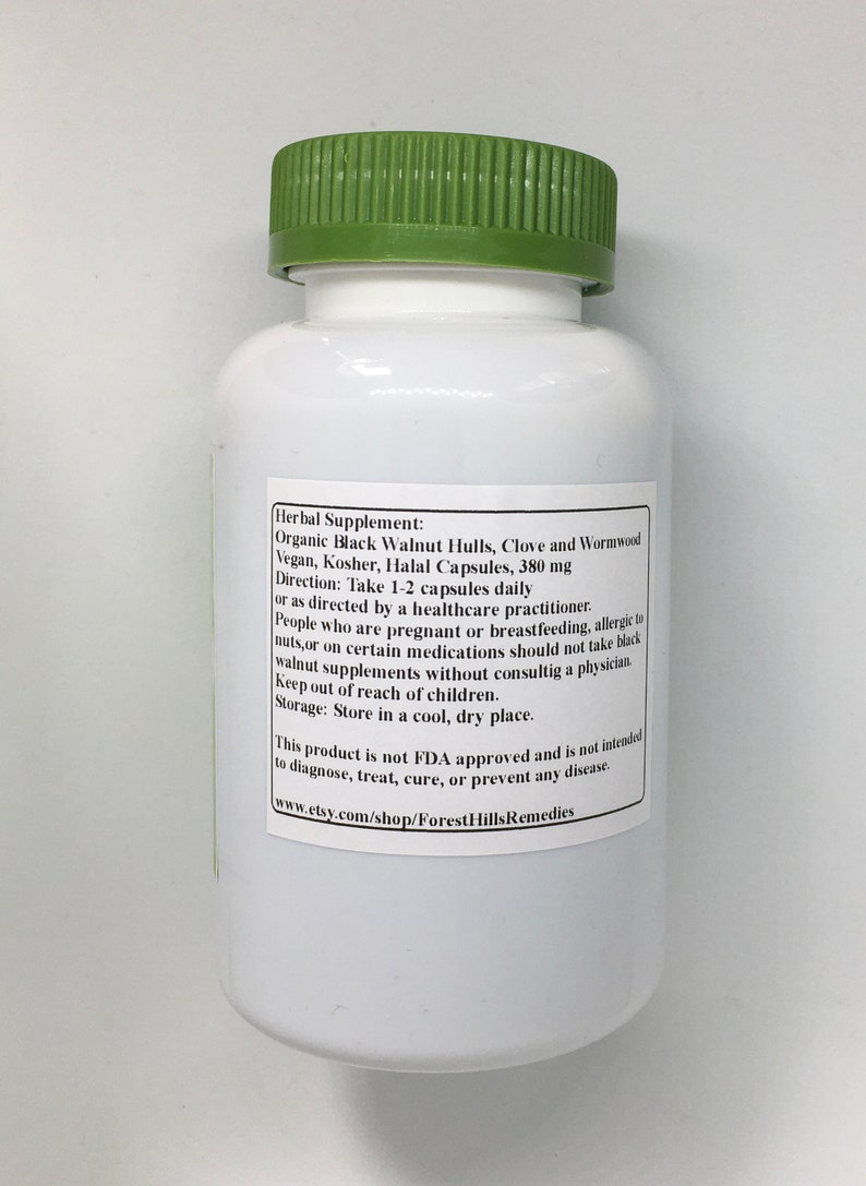 May include: White bottle with a green lid labeled "Herbal Supplement: Organic Black Walnut Hulls, Clove and Wormwood Vegan, Kosher, Halal Capsules, 380 mg Direction: Take 1-2 capsules daily or as directed by a healthcare practitioner. People who are pregnant or breastfeeding, allergic to nuts, or on certain medications should not take black walnut supplements without consulting a physician. Keep out of reach of children. Storage: Store in a cool, dry place. This product is not FDA approved and is not intended to diagnose, treat, cure, or prevent any disease. www.etsy.com/shop/ForestHillsRemedies"