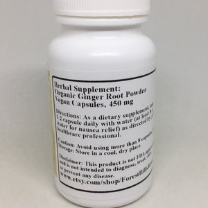 May include: White plastic bottle with a black label that reads "Herbal Supplement: Organic Ginger Root Powder Vegan Capsules, 450 mg". The label also includes directions for use, storage, and a disclaimer.