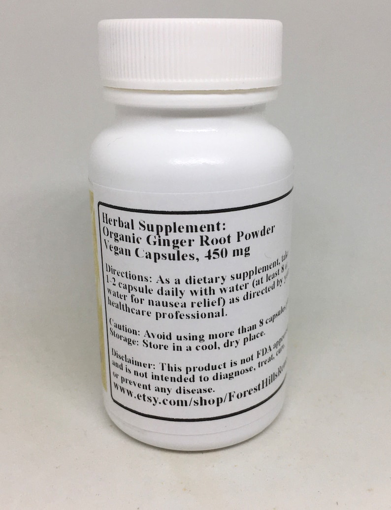 May include: White plastic bottle with a black label that reads "Herbal Supplement: Organic Ginger Root Powder Vegan Capsules, 450 mg". The label also includes directions for use, storage, and a disclaimer.
