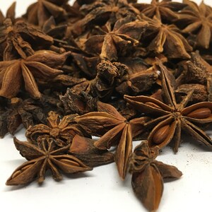 May include: A pile of dried star anise pods, a popular spice used in Asian cooking. The pods are brown and have a star shape with eight points.