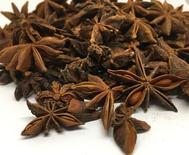 May include: A pile of dried star anise pods, a popular spice used in Asian cooking. The pods are brown and have a star shape with eight points.