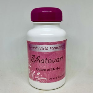 May include: White bottle with a purple lid labelled "Forest Hills Remedies Shatavari Queen of Herbs 90 Veg. Capsules"