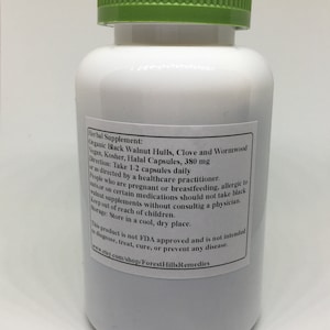 May include: White plastic bottle with a green lid, labeled "Herbal Supplement: Organic Black Walnut Hulls, Clove and Wormwood Vegan, Kosher, Halal Capsules, 380 mg Direction: Take 1-2 capsules daily or as directed by a healthcare practitioner. People who are pregnant or breastfeeding, allergic to nuts, or on certain medications should not take black walnut supplements without consulting a physician. Keep out of reach of children. Storage: Store in a cool, dry place. This product is not FDA approved and is not intended to diagnose, treat, cure, or prevent any disease. www.etsy.com/shop/ForestHillsRemedies"