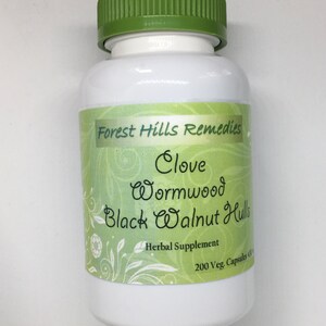 May include: White plastic bottle with a green lid, labeled "Forest Hills Remedies Clove Wormwood Black Walnut Hulls Herbal Supplement 200 Veg. Capsules 600mg"