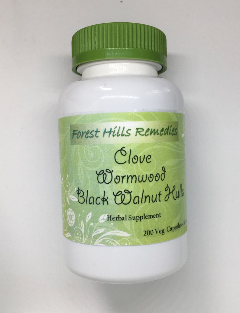 May include: White plastic bottle with a green lid, labeled "Forest Hills Remedies Clove Wormwood Black Walnut Hulls Herbal Supplement 200 Veg. Capsules 600mg"